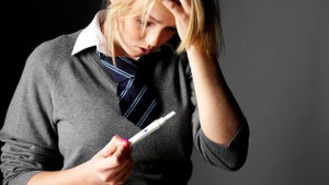 teen girl checks pregnancy test