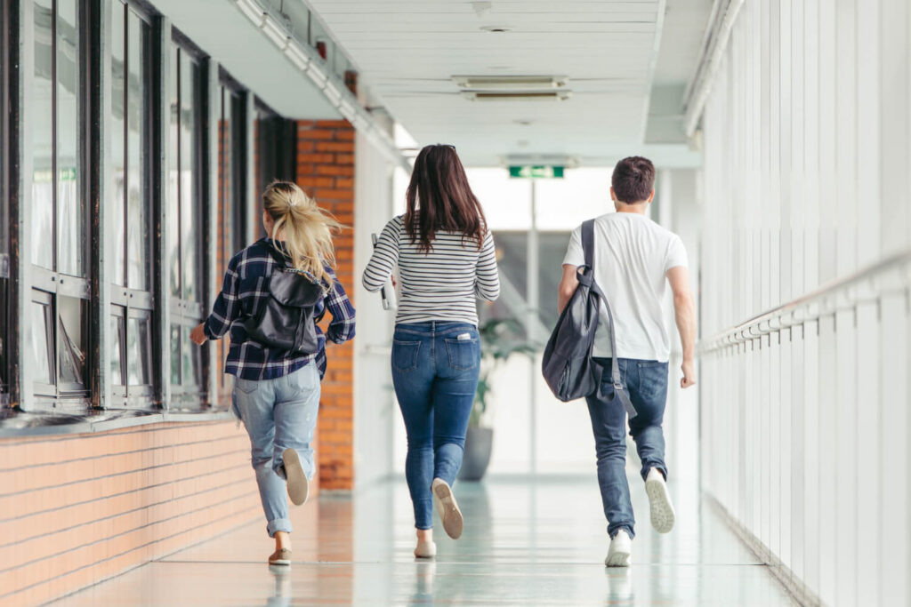 three students going away, school hallway