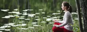 girl meditating with lotus flowers