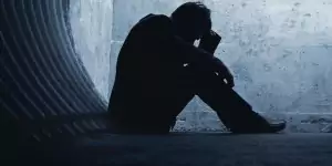 man sitting in blue alley