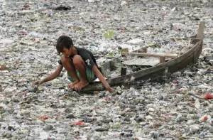 boy looking at dirty water