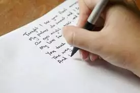 showing a hand writing a poem