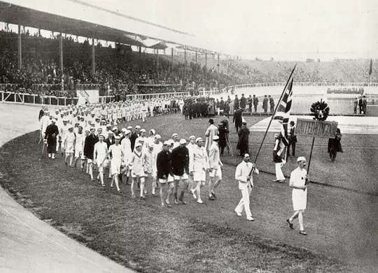 Photograph of Team GB in the opening ceremony's 'parade of nations,' from the Fourth Olympiad 1908 London. Official Report published by the <em></p><p id=