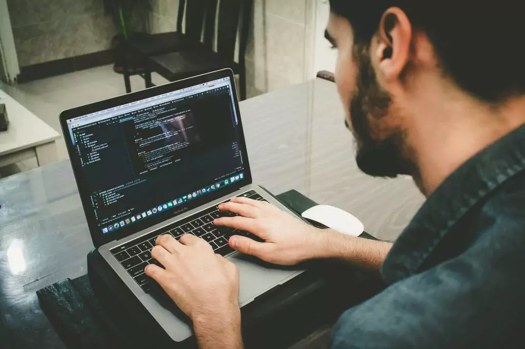 A young software enginner working on his laptop