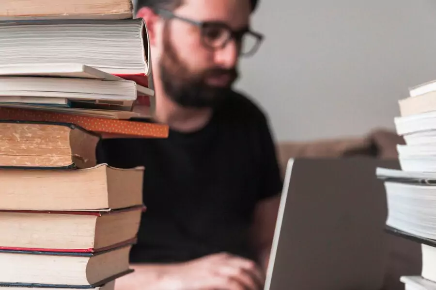 College student with laptop and books