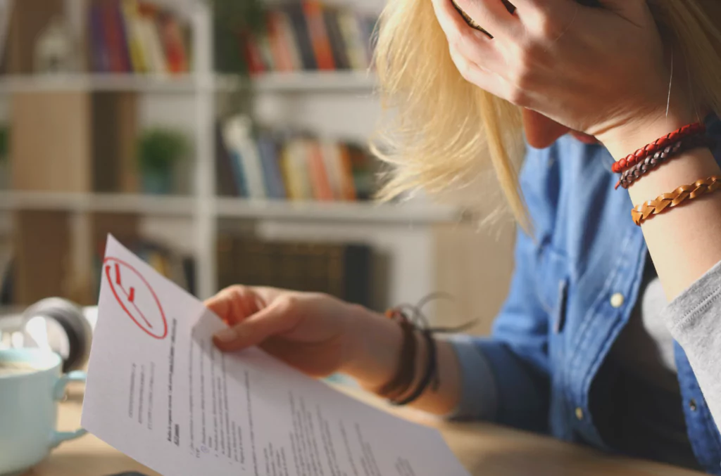 A student holding her exam with an F grade