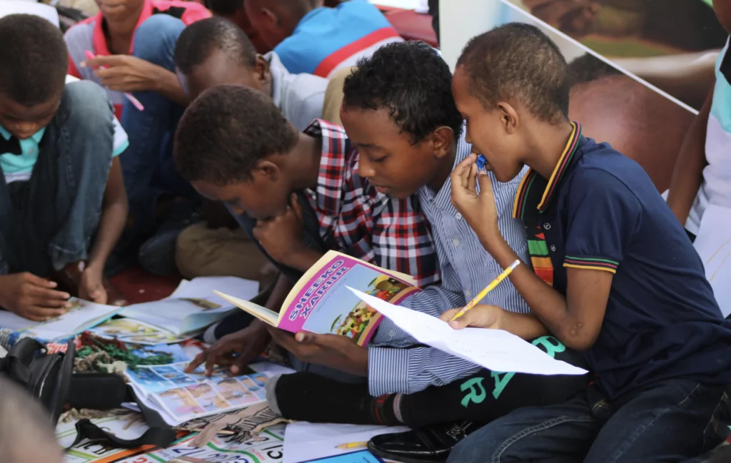 A photograph of non-English speaking students learning outside